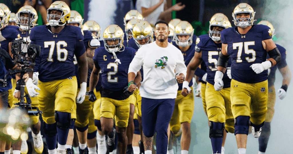 Notre Dame head coach Marcus Freeman runout