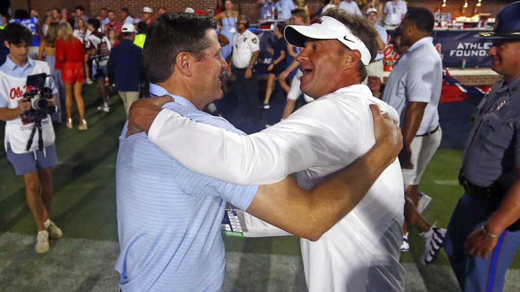 Ole Miss football head coach Lane Kiffin, right, and athletics director Keith Carter, left. Mandatory credit: Petre Thomas-Imagn Images