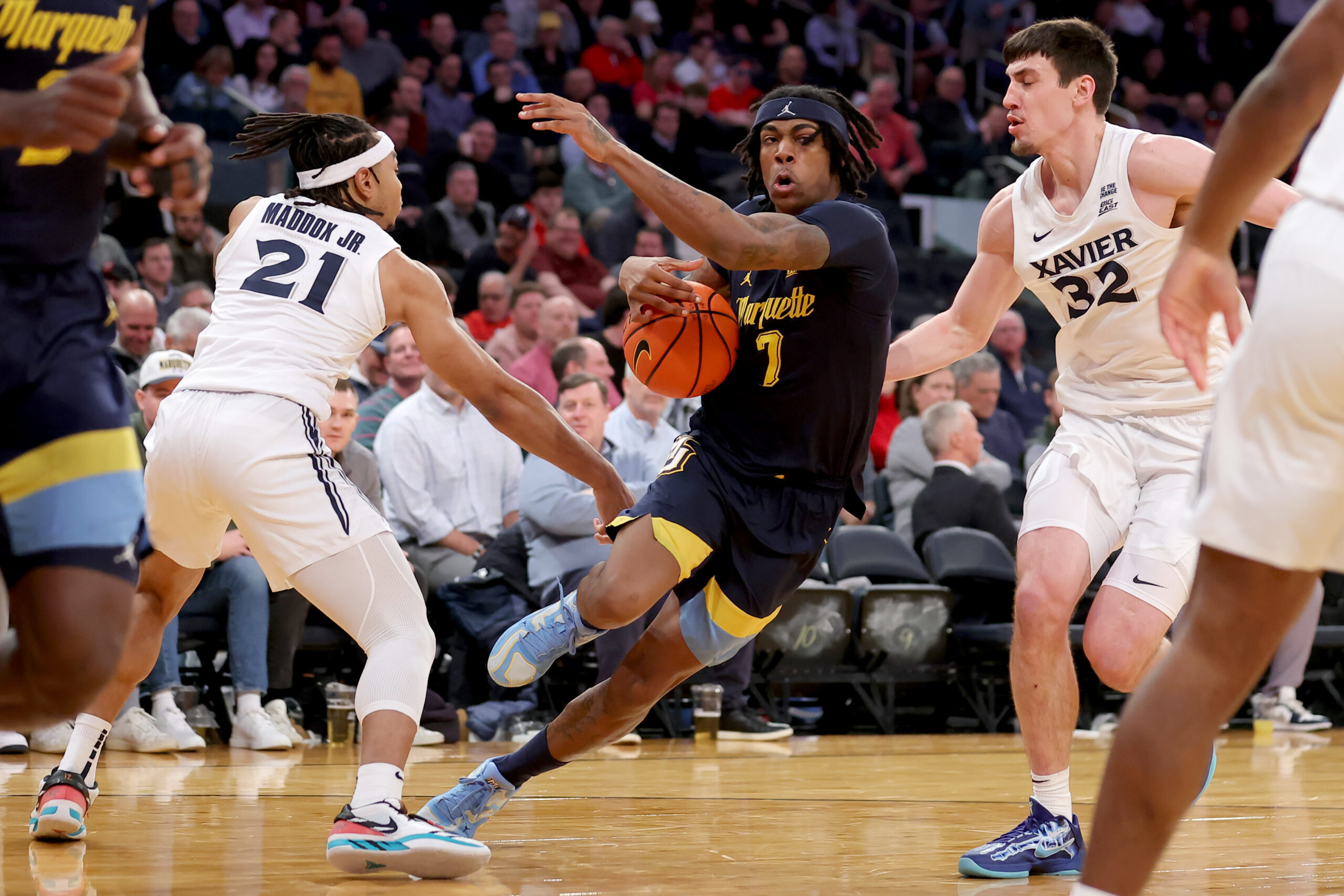Mar 13, 2025; New York, NY, USA; Marquette Golden Eagles guard Zaide Lowery (7) drives to the basket against Xavier Musketeers guard Dante Maddox Jr. (21) and forward Zach Freemantle (32) during the first half at Madison Square Garden. Mandatory Credit: Brad Penner-Imagn Images