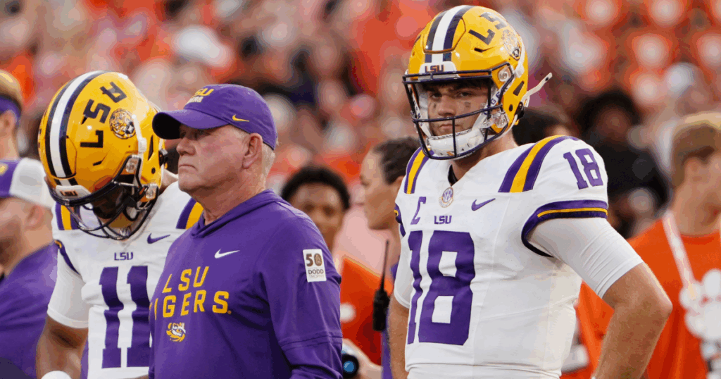 Aug 30, 2025; Clemson, South Carolina, USA; LSU Tigers head coach Brian Kelly and quarterback Garrett Nussmeier (18) look on during warmups before the game against the Clemson Tigers at Memorial Stadium.
