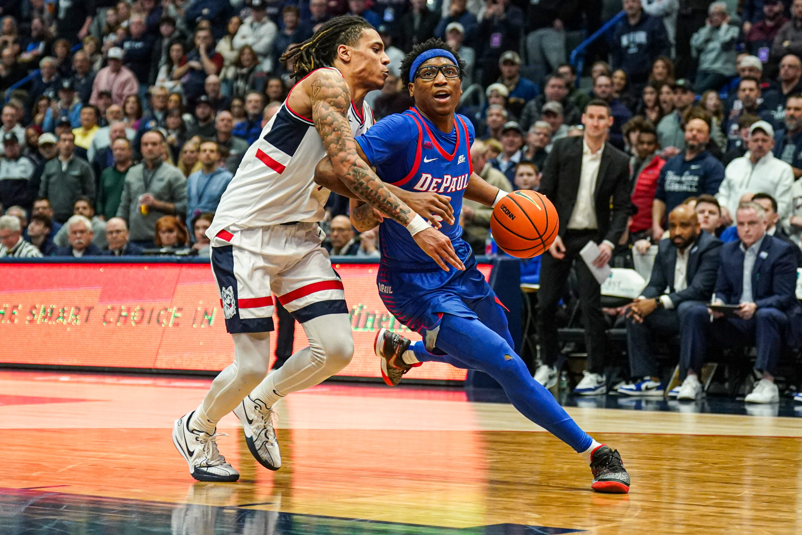 Jan 29, 2025; Hartford, Connecticut, USA; DePaul Blue Demons guard Layden Blocker (2) drives the ball against UConn Huskies guard Solo Ball (1) in the second half at XL Center. Mandatory Credit: David Butler II-Imagn Images