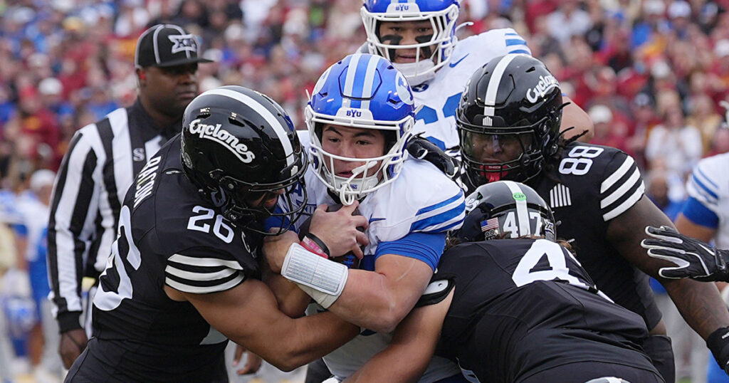 Iowa State Cyclones' linebacker Caleb Bacon (26) and linebacker Kooper Ebel (47) takes down BYU Cougars quarterback Bear Bachmeier (47) during the first quarter at Jack Trice Stadium on Oct. 25, 2025, in Ames, Iowa.