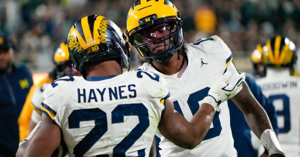 Oct 25, 2025; East Lansing, Michigan, USA; Michigan Wolverines running back Justice Haynes (22) reacts with quarterback Bryce Underwood (19) after scoring a touchdown against the Michigan Wolverines during the second half at Spartan Stadium. Mandatory Credit: Brendan Mullin-Imagn Images