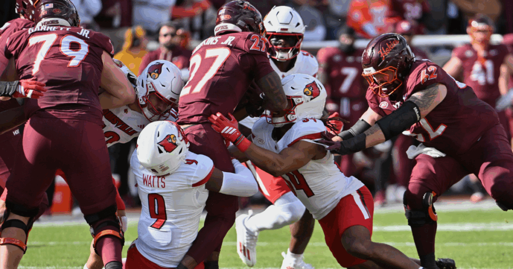 Nov 1, 2025; Blacksburg, Virginia, USA; Louisville Cardinals defensive back Antonio Watts (9) tackles Virginia Tech Hokies running back Marcellous Hawkins (27) during the first quarter at Lane Stadium. Mandatory Credit: Brian Bishop-Imagn Images