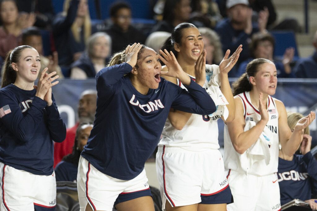 UConn's bench reacts to a play against Louisville