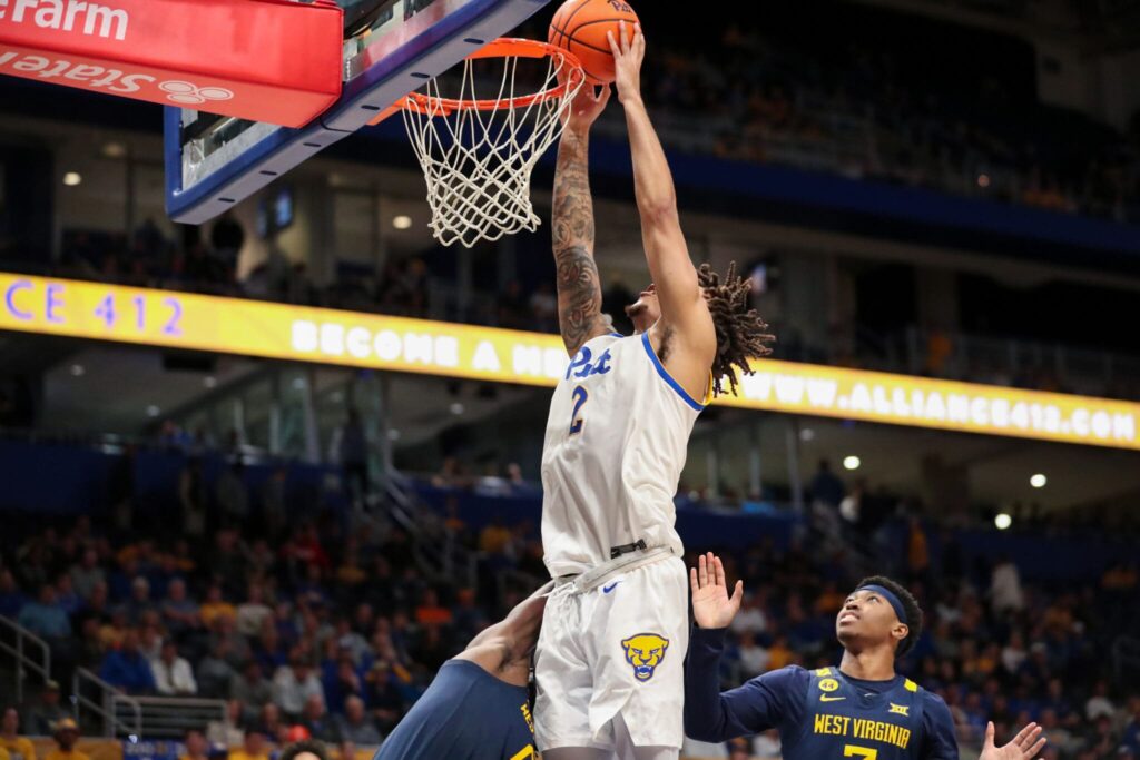 Pitt forward Cam Corhen jams a basket in the Backyard Brawl against West Virginia at the Petersen Events Center. Nov. 15, 2024 - David Hague / PSN