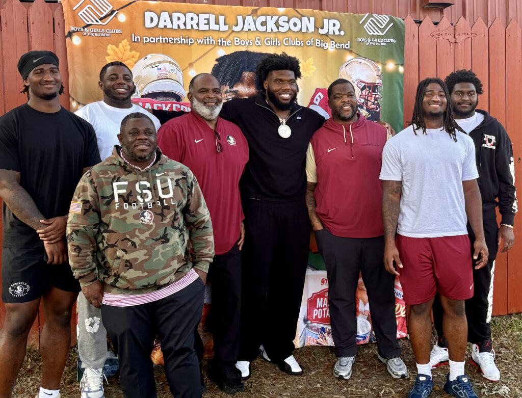 Florida State defensive tackle Darrell Jackson (center) poses for a photo with several of his fellow D-Linemen and coaches at his turkey giveaway on Monday. (Ira Schoffel/Warchant)