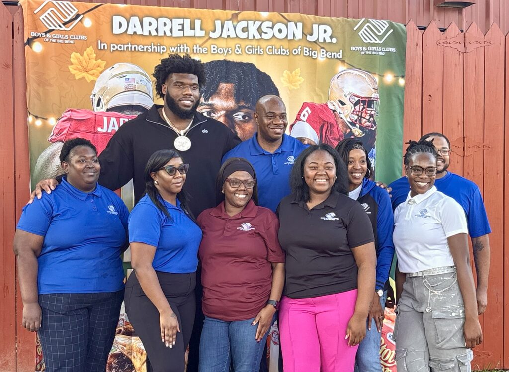 Florida State defensive tackle Darrell Jackson (center) poses for a photo with staff from the Boys & Girls Club of the Big Bend at his turkey giveaway on Monday. (Ira Schoffel/Warchant)