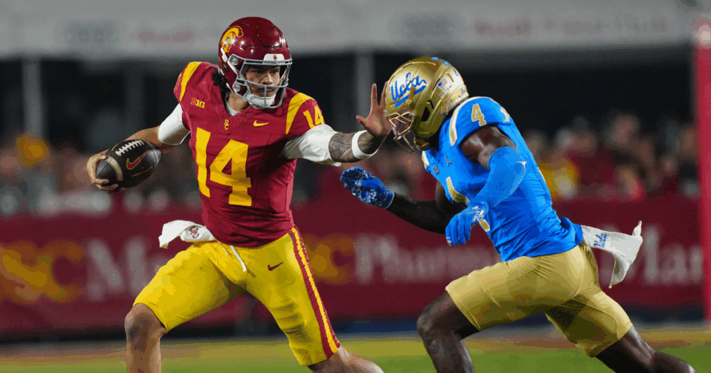USC Trojans quarterback Jayden Maiava (14) carries the ball against UCLA Bruins defensive back Key Lawrence (4) in the second half at United Airlines Field at Los Angeles Memorial Coliseum