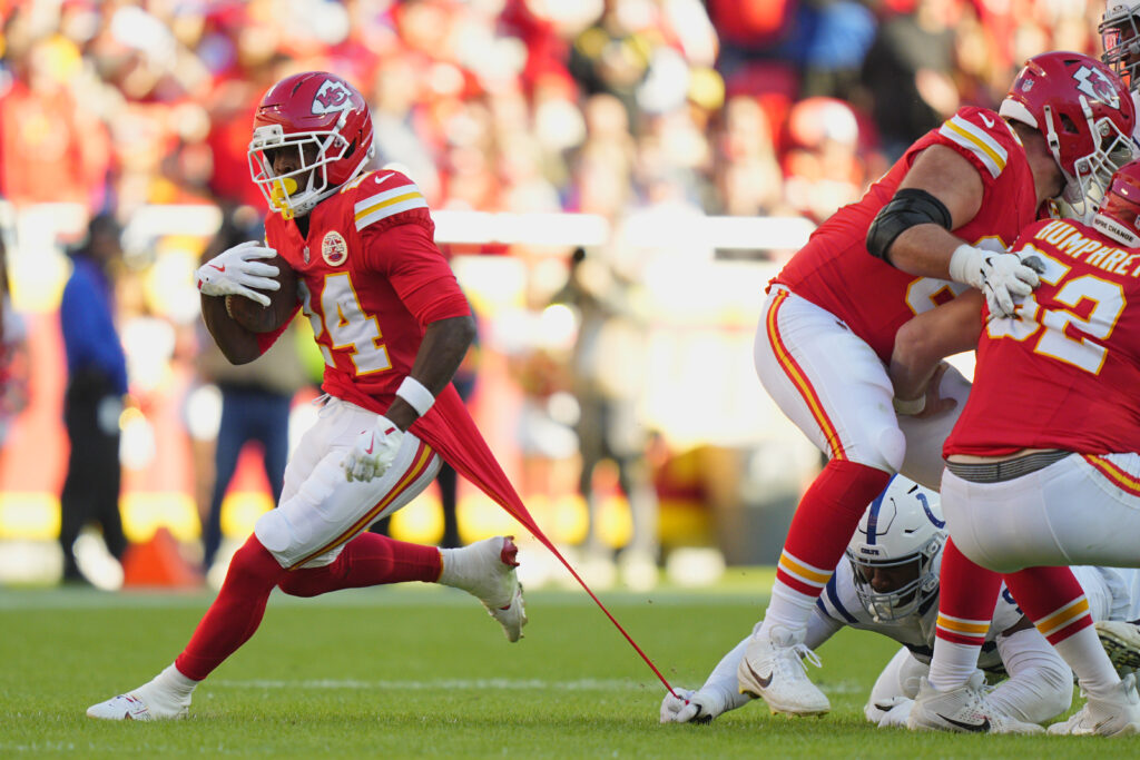 Nov 23, 2025; Kansas City, Missouri, USA; Kansas City Chiefs running back Brashard Smith (24) runs against Indianapolis Colts defensive tackle Adetomiwa Adebawore (95) in the second half at GEHA Field at Arrowhead Stadium. Mandatory Cre