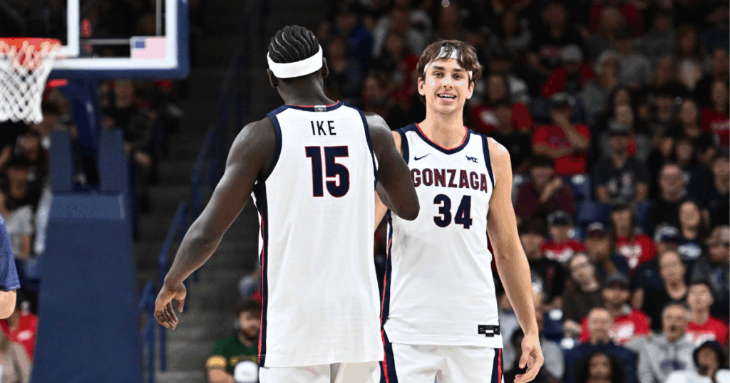 Oct 4, 2025; Spokane, WA, USA; Gonzaga Bulldogs forward Graham Ike (15) and Gonzaga Bulldogs forward Braden Huff (34) meet at center court during Numerica Kraziness in the Kennel at the McCarthey Athletic Center. Mandatory Credit: James Snook-Imagn Images