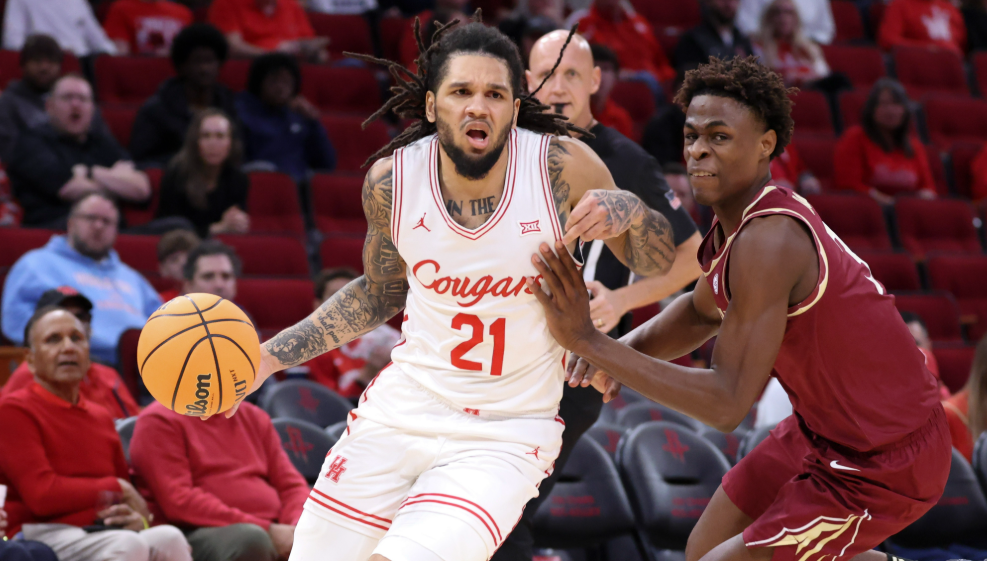Houston Cougars guard Emanuel Sharp (21) dribbles the ball as Florida State Seminoles forward Thomas Bassong (3) defends during the first half at Toyota Center. (Troy Taormina-Imagn Images)