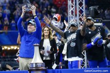 Florida-Gators-head-coach-Dan-Mullen-holds-the-Peach-Bowl-trophy.jpg